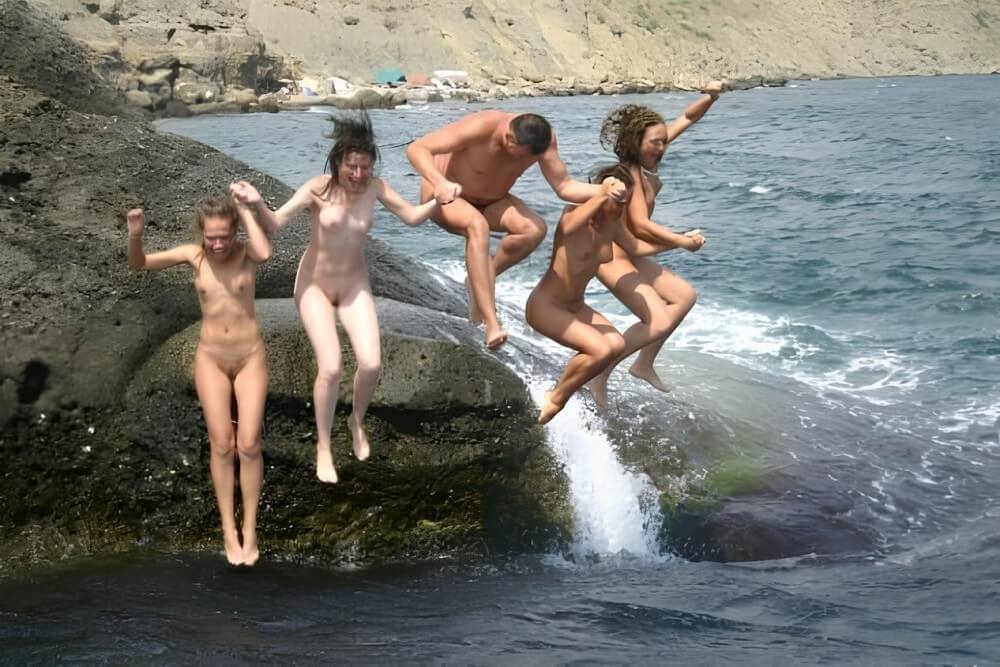 Mens and girls nudists on a beach - Nudism supports personal freedom and individuality