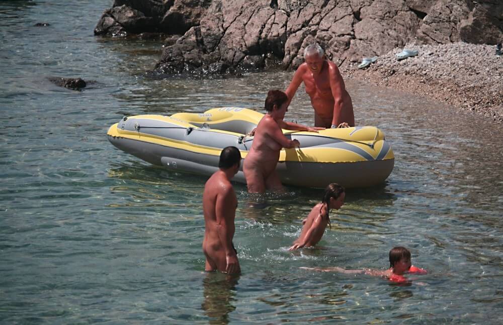 Lone Nudist in Yellow Boat photos - Naturism teaches respect for the natural world and for others